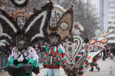 Pernik, Bulgaria - January 28, 2023: International masquerade festival Surva in Pernik, Bulgaria. People with mask called Kukeri dance and perform to scare the evil spirits.