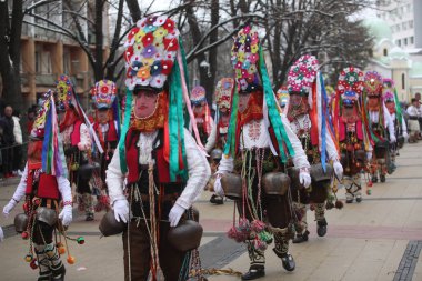 Pernik, Bulgaria - January 28, 2023: International masquerade festival Surva in Pernik, Bulgaria. People with mask called Kukeri dance and perform to scare the evil spirits.
