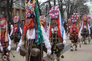 Pernik, Bulgaria - January 28, 2023: International masquerade festival Surva in Pernik, Bulgaria. People with mask called Kukeri dance and perform to scare the evil spirits.