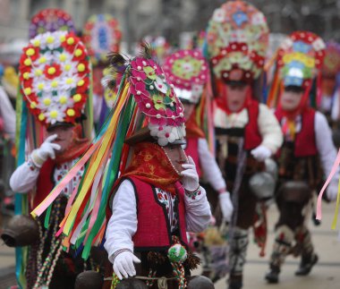 Pernik, Bulgaria - January 28, 2023: International masquerade festival Surva in Pernik, Bulgaria. People with mask called Kukeri dance and perform to scare the evil spirits.