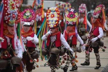 Pernik, Bulgaria - January 28, 2023: International masquerade festival Surva in Pernik, Bulgaria. People with mask called Kukeri dance and perform to scare the evil spirits.