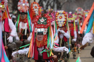 Pernik, Bulgaria - January 28, 2023: International masquerade festival Surva in Pernik, Bulgaria. People with mask called Kukeri dance and perform to scare the evil spirits.