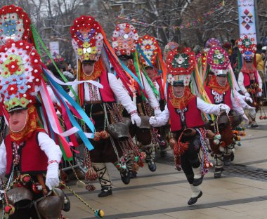 Pernik, Bulgaria - January 28, 2023: International masquerade festival Surva in Pernik, Bulgaria. People with mask called Kukeri dance and perform to scare the evil spirits.