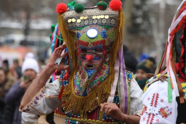Pernik, Bulgaria - January 28, 2023: International masquerade festival Surva in Pernik, Bulgaria. People with mask called Kukeri dance and perform to scare the evil spirits.