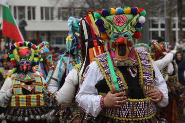 Pernik, Bulgaria - January 28, 2023: International masquerade festival Surva in Pernik, Bulgaria. People with mask called Kukeri dance and perform to scare the evil spirits.