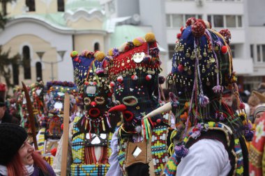 Pernik, Bulgaria - January 28, 2023: International masquerade festival Surva in Pernik, Bulgaria. People with mask called Kukeri dance and perform to scare the evil spirits.