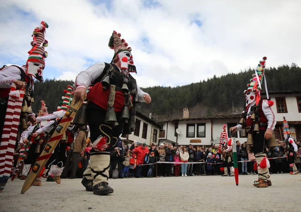 stock image Shiroka laka, Bulgaria - March 5, 2023: People with mask called Kukeri dance and perform to scare the evil spirits at the Festival of the Masquerade Games 