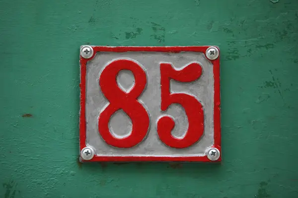 Vintage square ceramic street number plate with number. Close up, brand.
