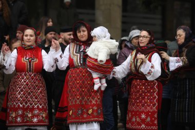 Razlog, Bulgaria - January 21, 2025: Residents of the city of Razlog, Bulgaria celebrate Babinden or the day of the midwife. The holiday is dedicated to the grannies who helped women give birth. clipart