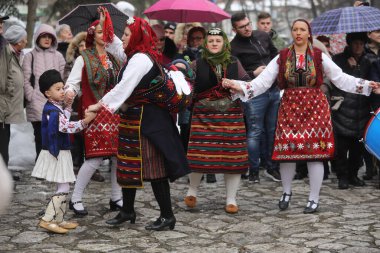 Razlog, Bulgaria - January 21, 2025: Residents of the city of Razlog, Bulgaria celebrate Babinden or the day of the midwife. The holiday is dedicated to the grannies who helped women give birth. clipart