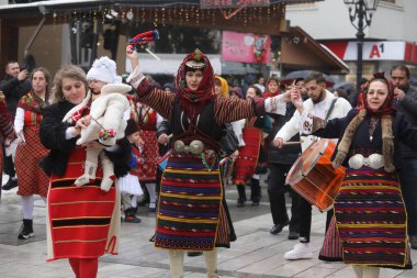 Razlog, Bulgaria - January 21, 2025: Residents of the city of Razlog, Bulgaria celebrate Babinden or the day of the midwife. The holiday is dedicated to the grannies who helped women give birth. clipart