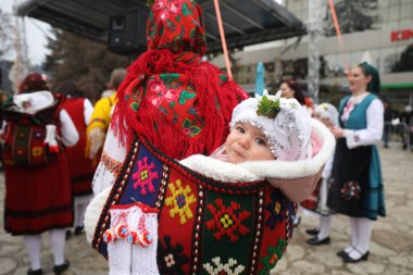 Razlog, Bulgaria - January 21, 2025: Residents of the city of Razlog, Bulgaria celebrate Babinden or the day of the midwife. The holiday is dedicated to the grannies who helped women give birth. clipart