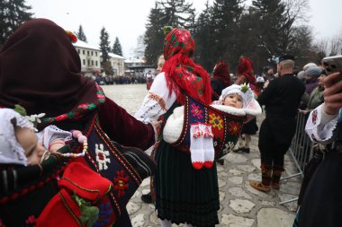 Razlog, Bulgaria - January 21, 2025: Residents of the city of Razlog, Bulgaria celebrate Babinden or the day of the midwife. The holiday is dedicated to the grannies who helped women give birth. clipart