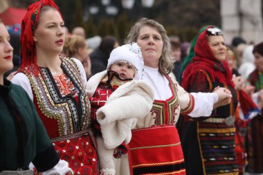 Razlog, Bulgaria - January 21, 2025: Residents of the city of Razlog, Bulgaria celebrate Babinden or the day of the midwife. The holiday is dedicated to the grannies who helped women give birth. clipart