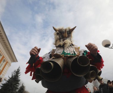 Pernik, Bulgaria - January 24, 2025: The 31th International masquerade festival Surva in Pernik, Bulgaria. People with mask called Kukeri dance and perform to scare the evil spirits. clipart