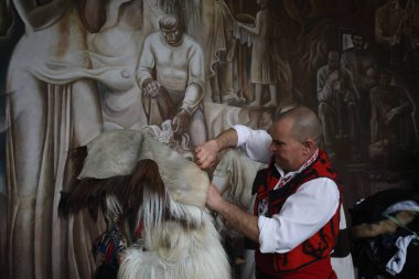 Pernik, Bulgaria - January 25, 2025: The 31th International masquerade festival Surva in Pernik, Bulgaria. People with mask called Kukeri dance and perform to scare the evil spirits. clipart