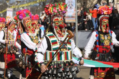 Pernik, Bulgaristan - 25 Ocak 2025: Bulgaristan 'ın Pernik kentinde düzenlenen 31. Uluslararası Maskeli Balo Festivali Surva. Kukeri adındaki maskeli insanlar dans ediyor ve kötü ruhları korkutmak için gösteri yapıyorlar..
