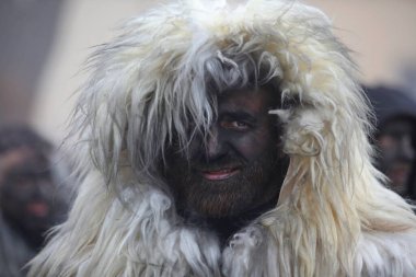 Pernik, Bulgaria - January 25, 2025: Cultural association presenting traditional masks Urthos and Buttudos Fonni, Italy participates in The 31th International masquerade festival Surva in Pernik, Bulgaria clipart