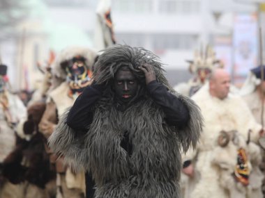 Pernik, Bulgaria - January 25, 2025: Cultural association presenting traditional masks Urthos and Buttudos Fonni, Italy participates in The 31th International masquerade festival Surva in Pernik, Bulgaria clipart