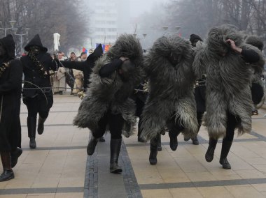 Pernik, Bulgaria - January 25, 2025: Cultural association presenting traditional masks Urthos and Buttudos Fonni, Italy participates in The 31th International masquerade festival Surva in Pernik, Bulgaria clipart