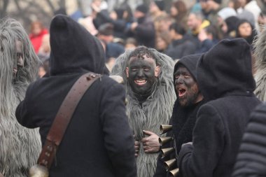 Pernik, Bulgaria - January 25, 2025: Cultural association presenting traditional masks Urthos and Buttudos Fonni, Italy participates in The 31th International masquerade festival Surva in Pernik, Bulgaria clipart