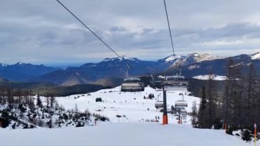 Waidring, Austria - 01.15.2023: View of the cable car carrying skiers, in the background of the mountain range