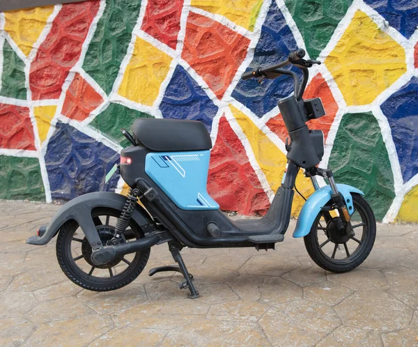 stock image A single seater electric scooter parked on a sidewalk