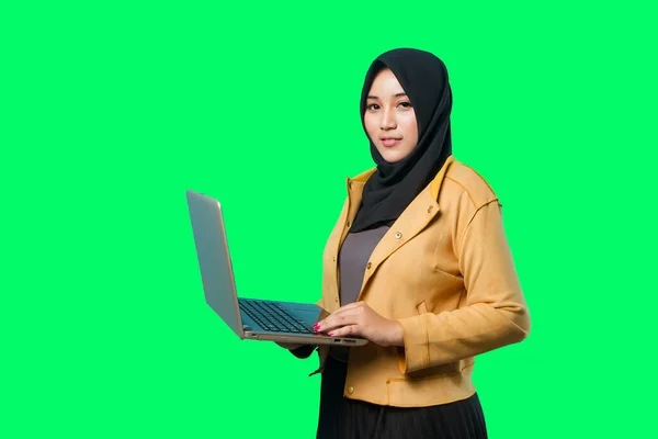 beautiful moslem asian business woman holding her laptop with happy smile on isolated background