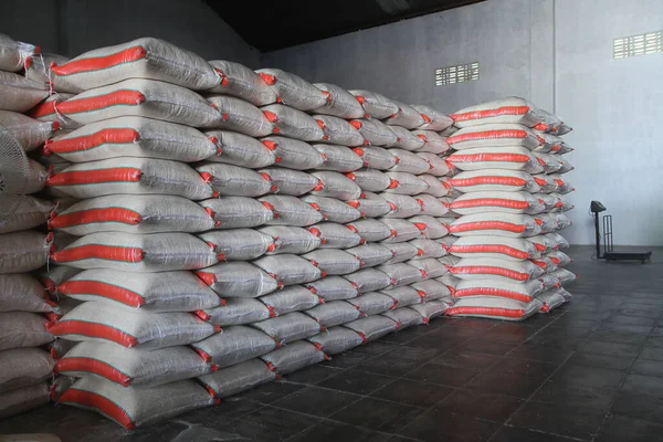 Stack hemp sacks of rice. Pile of rice sacks in grain warehouse