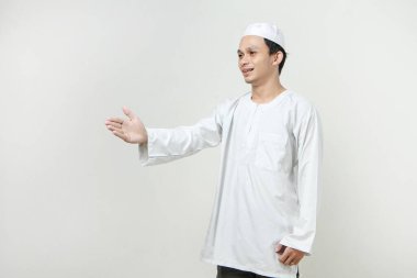 Mutlu Asyalı Müslüman adam el sıkışma hareketi yapıyor. İnsanlar dini İslam yaşam tarzı kavramını benimsiyor. Ramazan ve Mübarek bayramını kutluyoruz. izole edilmiş arka grupta