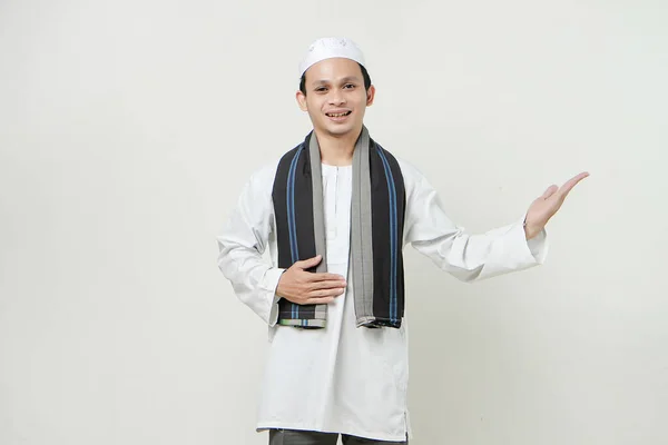 asian muslim man with presenting hand gesture. People religious Islam lifestyle concept. celebration Ramadan and ied Mubarak. on isolated backgroun