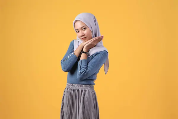 stock image happy asian indonesian muslim women with hope hand gesture on isolated yellow background