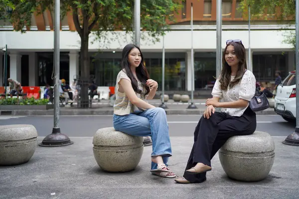 Malioboro caddesinde oturan iki genç Asyalı kadın, Yogyakarta, Endonezya