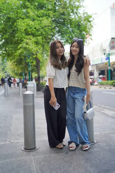 İki genç Asyalı kadın Malioboro caddesinde duruyor, Yogyakarta, Endonezya