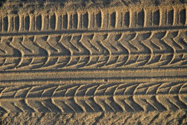 Abstract texture, tyre  tracks in coarse beach sand