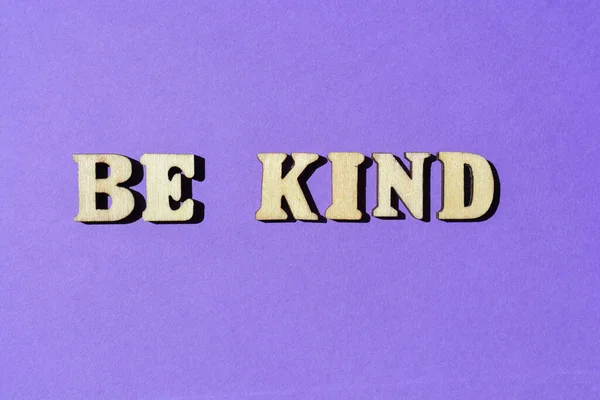 友善点 在紫色背景下孤立的木制字母表中的单词作为横幅标题 — 图库照片