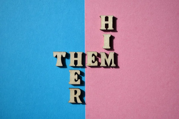 stock image Him, Them, Her, words in wooden alphabet letters in crossword form isolated on pink and blue background