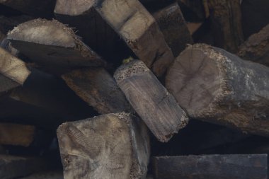 Köhne bir depoda eski ahşap sütunlar yığını