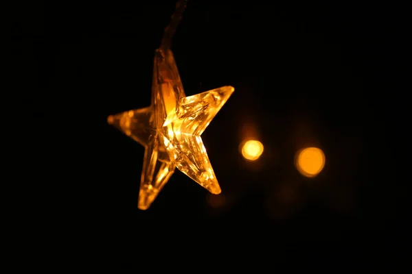 stock image Christmas wallpaper.Star burning on a dark background.Christmas and New Year festive background.