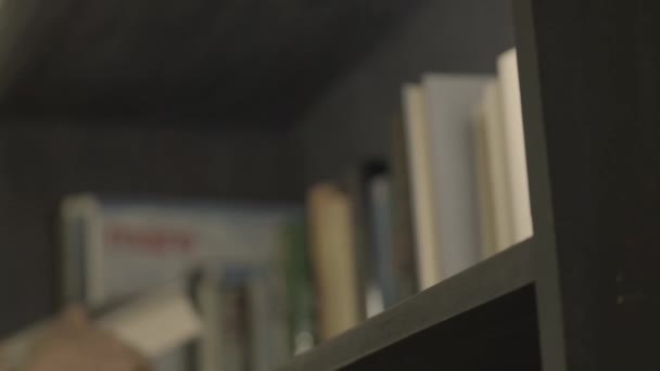 Bookshelves Hands Put Books Shelves Soft Focus Slow Motion Reading — Stock Video