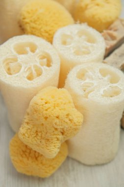 Eco friendly bio natural cosmetics.Zero waste.Natural cognac sponges and loofah washcloths on a wooden white shabby board.Hygiene and health concept.