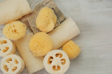 Zero waste Hygiene products set.reasonable consumption. Natural cognac sponges and loofah washcloths on a wooden white shabby board.Hygiene and health concept.Eco friendly bio natural cosmetics. 