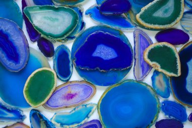 Agate geode crystal. Agates set in blue and green colors.slices of natural stone on white background.Texture of natural stone agate.blue Cross section of a blue geode 