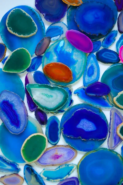 Surface of agate stones in blue and green colors.slices of natural stone on white background. .Texture of natural stone agate.blue Agate geode crystal.Cross section of a blue Brazilian geode