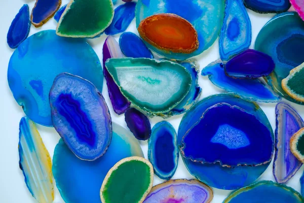 Wallpaper agate stones in blue and green colors.slices of natural stone on white background. .Texture of natural stone agate.blue Agate geode crystal.Cross section of a blue Brazilian geode