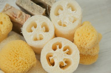  Hygiene products.reasonable consumption.Zero waste. Natural cognac sponges and loofah washcloths on a wooden white shabby board.Hygiene and health concept.Eco friendly bio natural cosmetics.