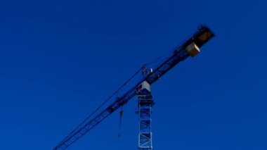Building.Construction crane. Construction machinery on blue sky background. New house construction. 4k footage