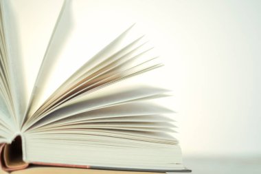 Learning and knowledge symbol.Reading and education. Open books on a light background with a yellow gradient.stack of books on a wooden tableLiterature and reading concept.