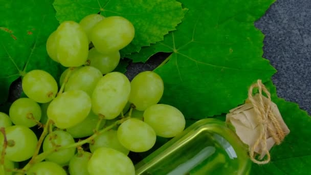Grape Oil Green Grapes Leaves Oil Transparent Bottle Black Slate — стоковое видео