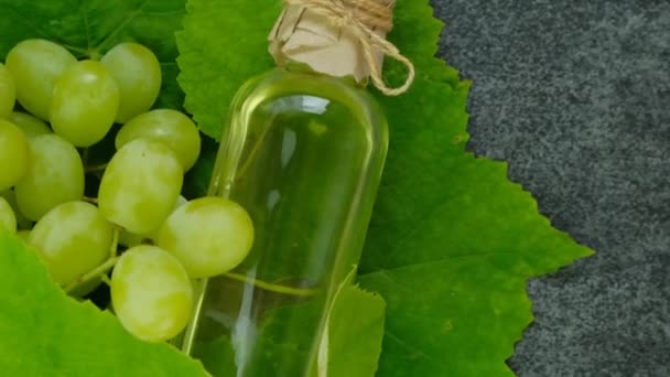 葡萄油 有机油 绿葡萄 叶和油装在透明的瓶子里 葡萄籽油 慢动作 4K镜头 — 图库视频影像